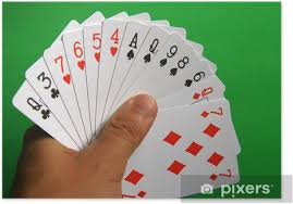 a hand with many playing cards